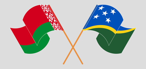 Crossed and waving flags of Belarus and Solomon Islands