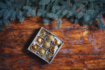 Christmas gold ornaments on the wooden background