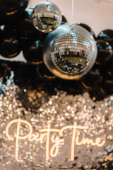 Disco ball. Happy New Year 2023. Bright glowing disco ball on photo booth with decor text party...