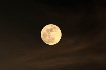 Fototapeta premium image of a full moon at night on a cloudy sky