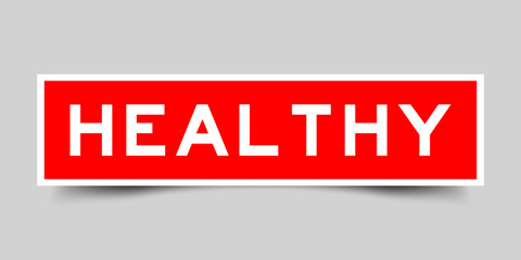 Sticker label with word healthy in red color on gray background