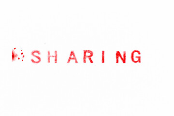 Red color ink rubber stamp in word sharing on white paper background