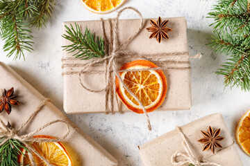 Christmas present with dry citruses and fir tree branches on white background.