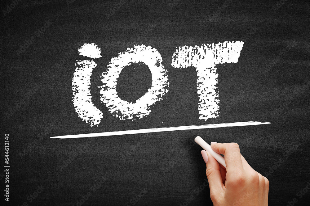Poster IOT Internet Of Things - physical objects that are embedded with sensors, and other technologies that connect and exchange data with other devices over the Internet, acronym text on blackboard