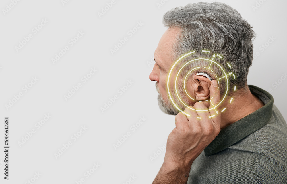 Wall mural senior man can hear sounds with hearing aid behind the ear with virtual sound waves. hearing loss tr