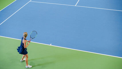 Female Tennis Player Just Served by Hitting Ball with a Racquet During Championship Match. Professional Woman Athlete Successfully Strikes. World Sports Tournament. High Angle Shot.