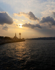 Fototapeta na wymiar Orange sunset sky and sun over the sea. Silhouette of the city of Istanbul on the horizon.