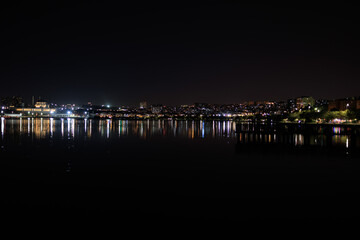 Night sky and light over the sea. Silhouette of the city of Istanbul.
