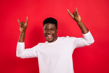 Portrait of childish positive person two arms fingers show heavy metal symbol isolated on red color background