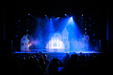 The stage of the theater illuminated by spotlights from the auditorium