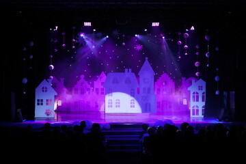 The stage of the theater illuminated by spotlights from the auditorium