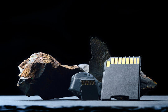 Composition of micro sd cards and dark stones. close-up