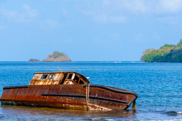 Rusty aground boat on the caribbean waters