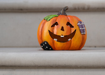 Halloween decorations of traditional english house. Carved pumpkin on the doorstep.