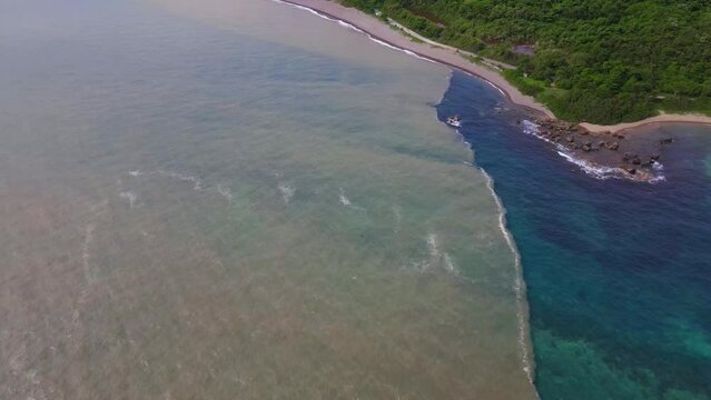 aerial view of river water merging with sea water