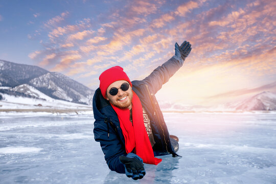 Tourist man with red scarf background ice with gas methane bubbles lake Baikal sunset. Adventure winter travel top view