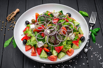 Greek salad with olive oil, fresh vegetables, olives and fetta cheese
