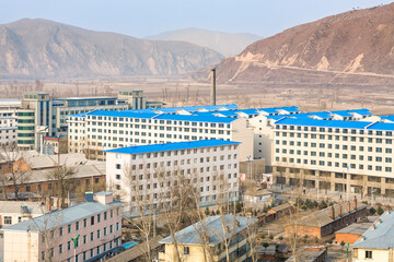TUMEN, JILIN PROVINCE, CHINA - April 2008: contrast between modern Tumen buildings with blue roofs...