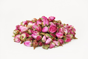 tea made from dried buds and petals of a pink rose on a white background