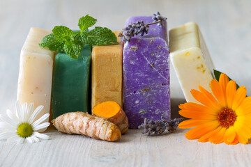 Assortment of natural soaps with medicinal plants, flowers and turmeric