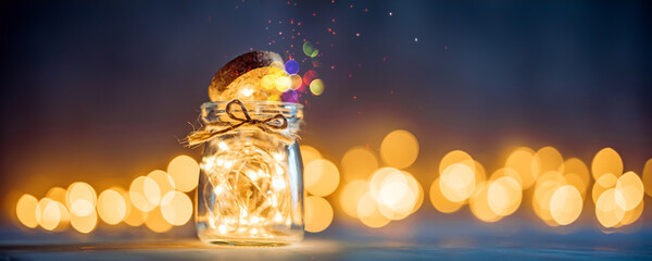 Small glass jar with Christmas lights and bokeh in the background