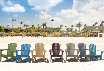 Wooden chairs on white sand. Aruba beach