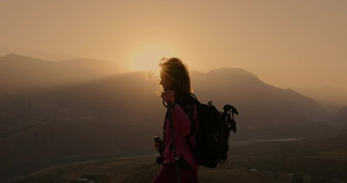 30s Woman Hiking In The Mountains At Dawn. A Silhouette Shot. Slow Motion
