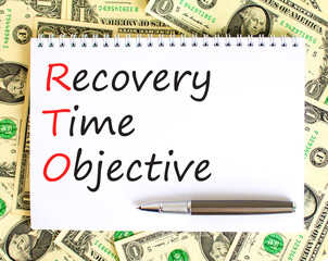 RTO recovery time objective symbol. Concept words RTO recovery time objective on white note on a beautiful background from dollar bills. Business and RTO recovery time objective concept. Copy space.