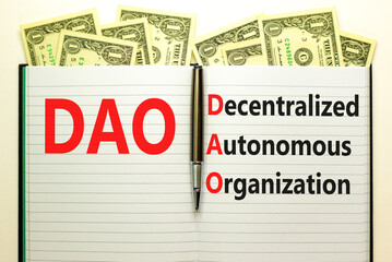 DAO decentralized autonomous organization symbol. Concept words DAO decentralized autonomous organization on white note on a beautiful white background. Business and DAO concept. Copy space.