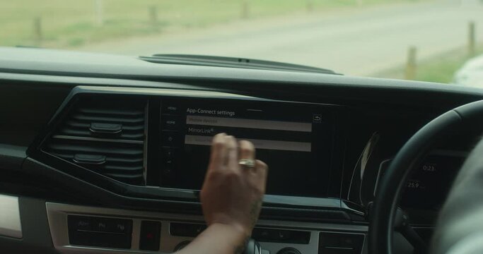 CU Woman using dashboard touchscreen in van