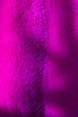 Tree branch shadow falls on soft pink furry fabric background macro view. Trendy design element for artworks. Stylish decorative element