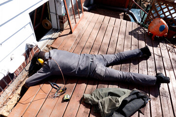 Workman repairing wiring connecting the fuse box to a rod outside for grounding. St Paul Minnesota MN USA