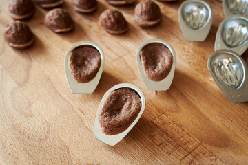 Preparation of homemade Christmas cookies in the form of nuts