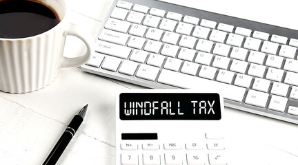 WINDFALL TAX text on calculator with keyboard and coffee