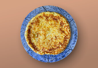 Khachapuri on a plate stands on an iron table. Hot cheese flatbread. Hearty tasty breakfast or snack. Background for the site, banner, flyer.