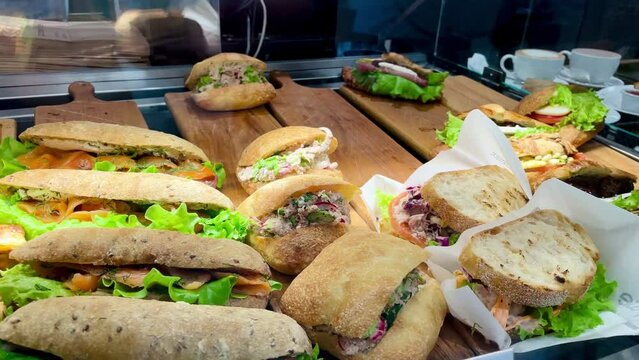 Delicious sandwiches snacks on the window of the cafe behind the glass. High quality 4k footage