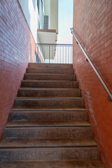 stairs to the light with old brick wall