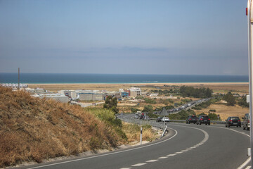 Fototapeta na wymiar MEDITERRANEAN ROAD ON THE COSTA DORADA OF SPAIN, BETWEEN MALAGA AND GIBRALTAR WITH THE SEA IN THE BACKGROUND AND SURROUNDED BY MOUNTAINS