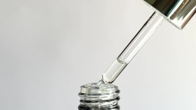 Close up of a cosmetic pipette on a white background.
