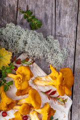 Raw wild mushrooms chanterelles on old wooden background. Vegetarian healthy product. Healthy lifestyle. - 544668172