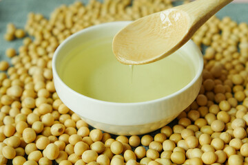 close up of Raw soy bean seed and oil in a container 