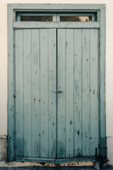 Closed old blue wooden window shutters 