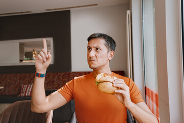 The annoyed and frustrated Man gestures to the waiter in the restaurant. Stale and spoiled food or...