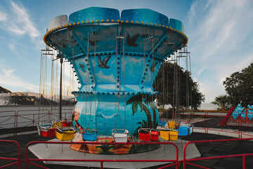 A carousel in an empty amusement park on an autumn evening
