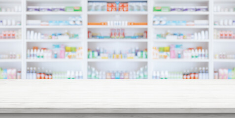 Empty white wood counter top with blur pharmacy drugstore shelves background - obrazy, fototapety, plakaty