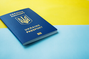 Passport on the background of the Ukrainian Flag, closeup with space for text. International relationships.