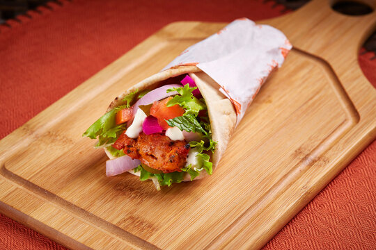Shish Tawook Shawarma wrap or Sheesh Tawook Sandwich served in dish isolated on table side view of middle east food