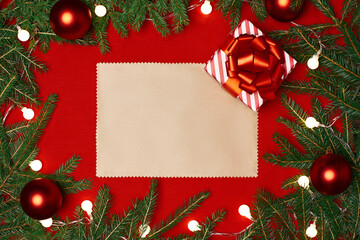 Fototapeta na wymiar blank sheet of paper and a Christmas gift and on a red festive background.