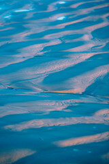Fototapeta na wymiar Detail of golden light reflecting on the sand.