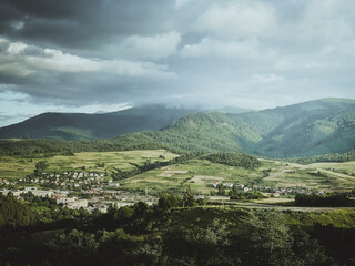 Mountain view on green valley with small village in Ukraine